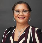 Headshot of author Kim Greenfield Alfonso, a Black woman wearing glasses and smiling.